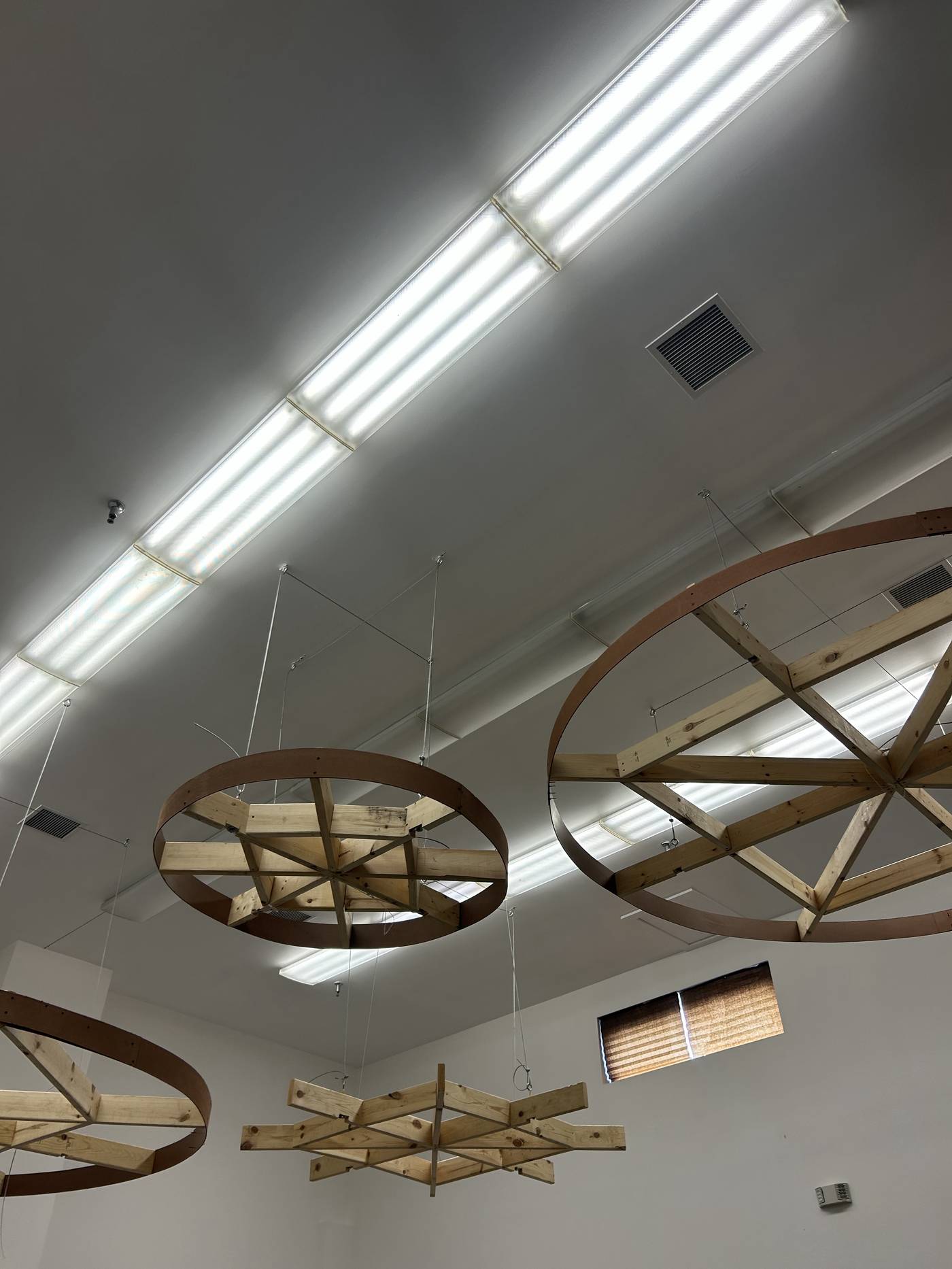 Interior ceiling detail with wood ring pendant fixtures